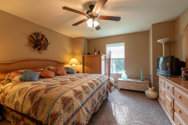 bedroom featuring a textured ceiling, a ceiling fan, and carpet flooring