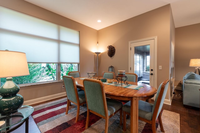 dining room featuring baseboards, dark wood finished floors, and a healthy amount of sunlight