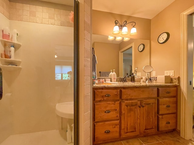 bathroom with tile patterned flooring, a walk in shower, and a sink