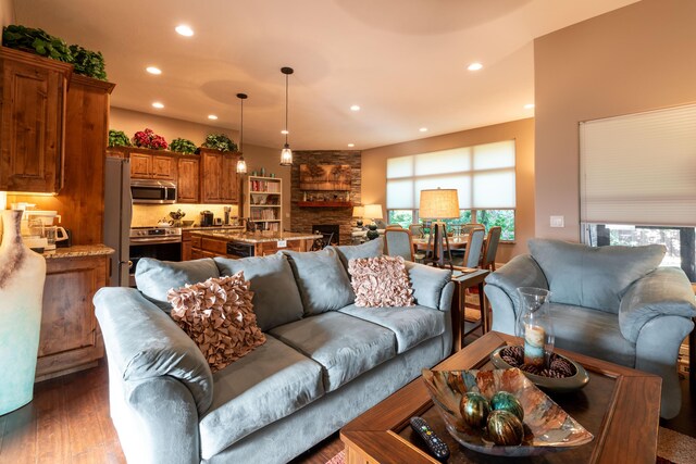 living area featuring a fireplace, wood finished floors, and recessed lighting