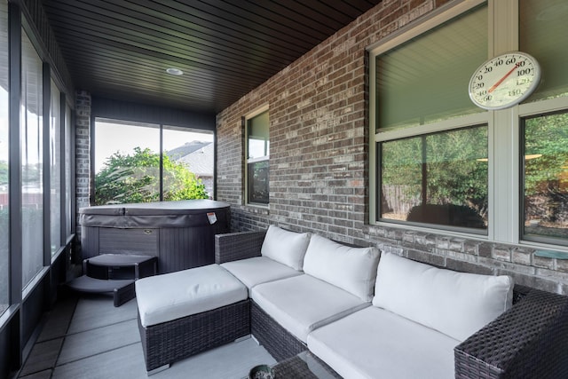 sunroom featuring a hot tub