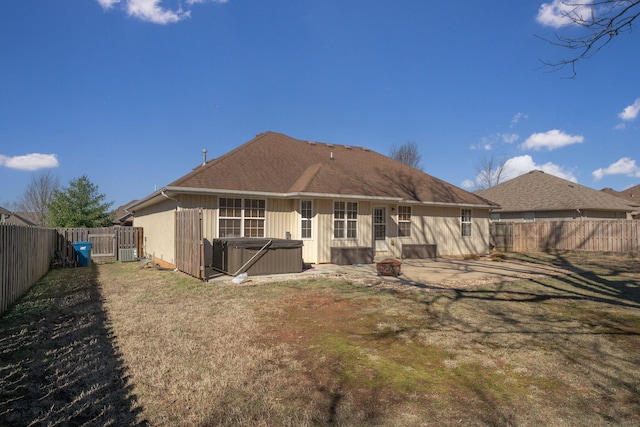 back of property featuring a fenced backyard, central air condition unit, a lawn, a patio area, and a hot tub