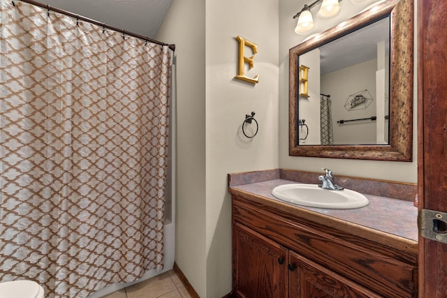 bathroom with shower / bathtub combination with curtain, vanity, and tile patterned floors