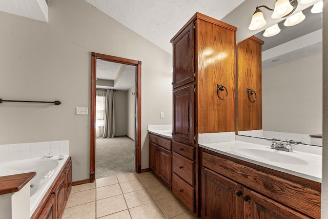 full bathroom featuring a garden tub, lofted ceiling, vanity, a textured ceiling, and tile patterned flooring