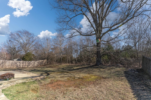 view of yard with an outdoor fire pit and fence