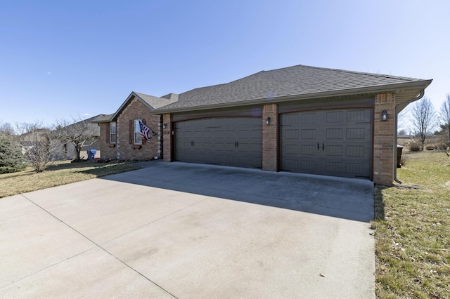 ranch-style house with a shingled roof, concrete driveway, and brick siding