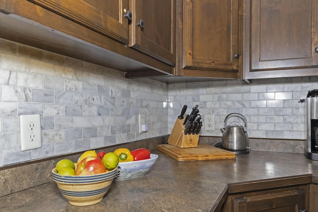 kitchen featuring dark countertops and decorative backsplash