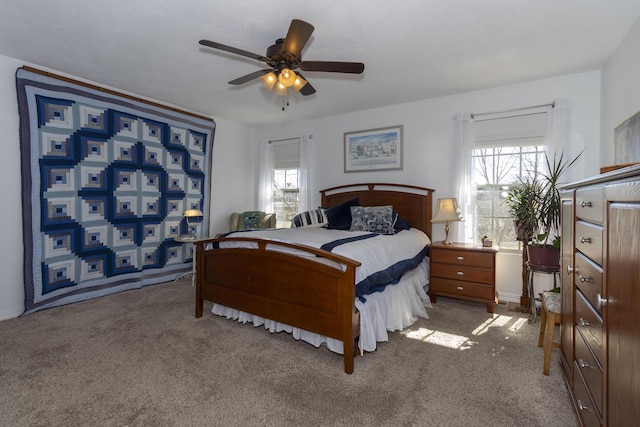 bedroom with multiple windows, ceiling fan, and carpet flooring