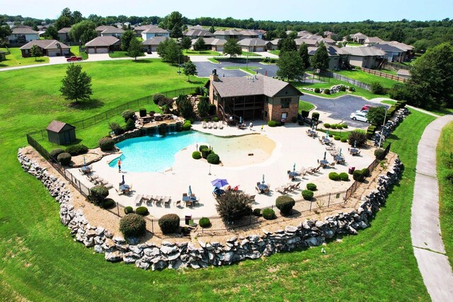 view of swimming pool with a fenced in pool, a patio, a residential view, fence, and a yard