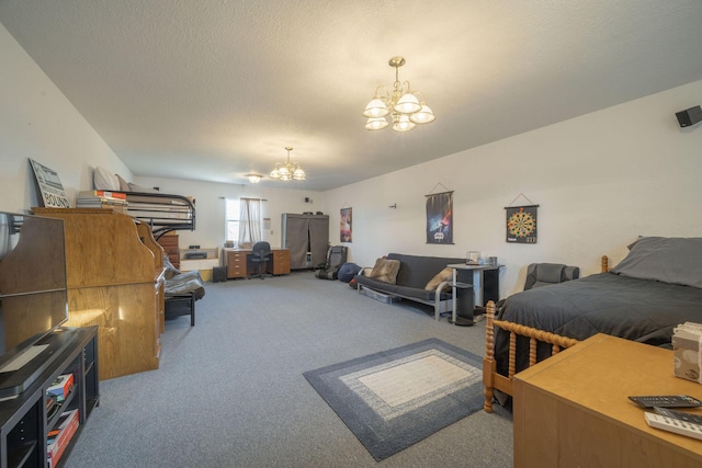 carpeted bedroom featuring a notable chandelier and a textured ceiling