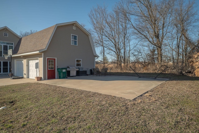 view of home's exterior featuring a yard, a shingled roof, a gambrel roof, a garage, and driveway