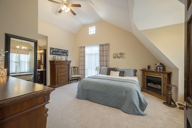 bedroom with ceiling fan with notable chandelier, high vaulted ceiling, and carpet