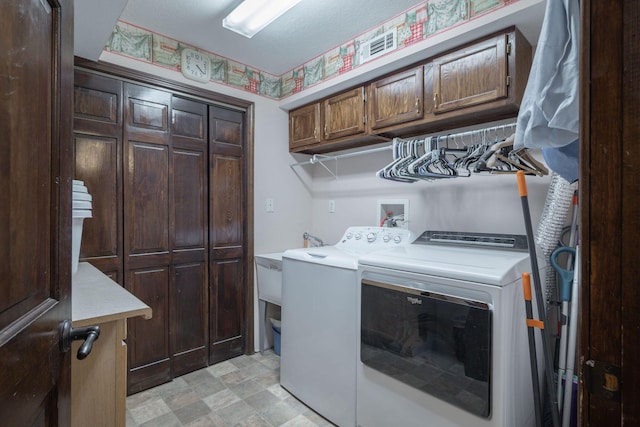 clothes washing area with cabinet space and washing machine and clothes dryer