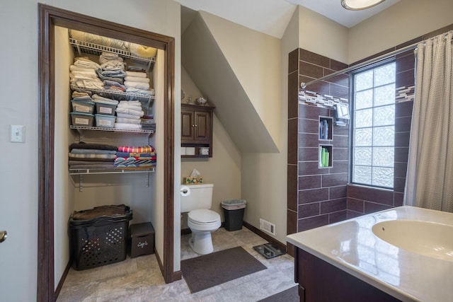 bathroom featuring toilet, baseboards, visible vents, and vanity