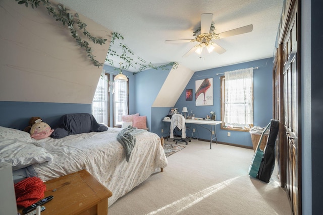 carpeted bedroom with multiple windows, vaulted ceiling, and a textured ceiling