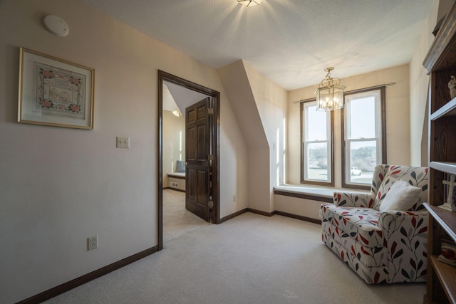 sitting room featuring light carpet, an inviting chandelier, baseboards, and a textured ceiling