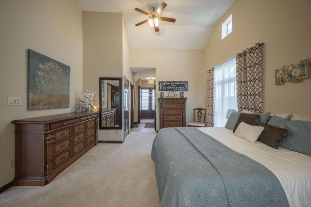 bedroom featuring high vaulted ceiling, light colored carpet, multiple windows, and baseboards