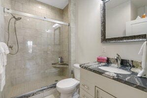 212 W Main St, Branson, MO 65616 - bathroom featuring vanity, a shower stall, and toilet