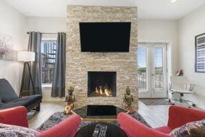 212 W Main St, Branson, MO 65616 - living room featuring a fireplace, wood finished floors, and french doors