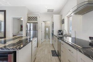 212 W Main St, Branson, MO 65616 - kitchen featuring visible vents, white cabinets, dark stone counters, wine cooler, and light wood-style floors