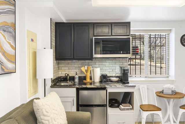 212 W Main St, Branson, MO 65616 - bar with appliances with stainless steel finishes, decorative backsplash, and a sink