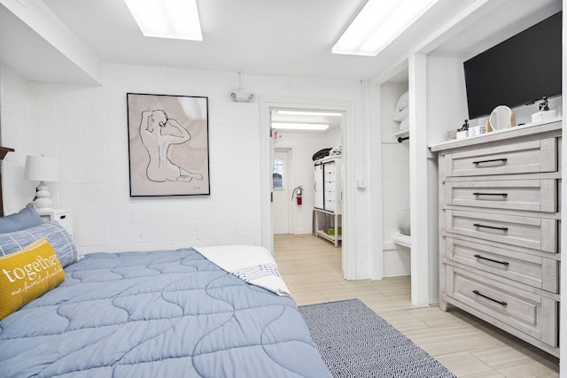212 W Main St, Branson, MO 65616 - bedroom featuring concrete block wall and wood tiled floor