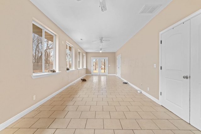 unfurnished room with ceiling fan, french doors, a wealth of natural light, and visible vents