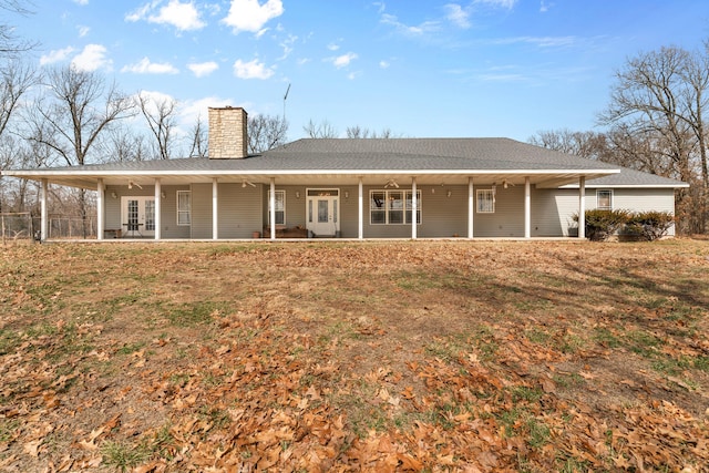 rear view of property featuring a patio, french doors, and a chimney