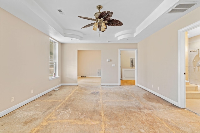 unfurnished room featuring baseboards, visible vents, ceiling fan, and a tray ceiling