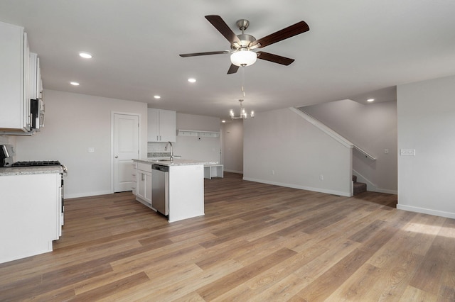 kitchen featuring light wood finished floors, appliances with stainless steel finishes, a kitchen island with sink, and white cabinetry