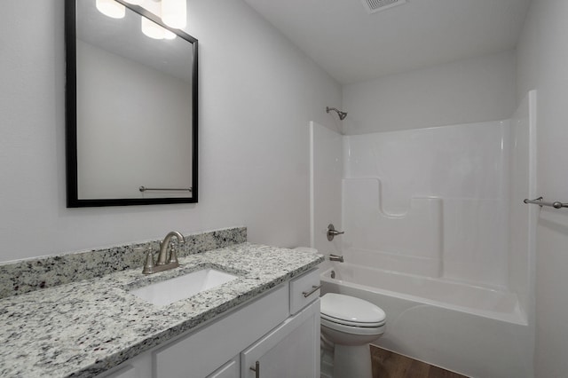 bathroom with wood finished floors, shower / bath combination, vanity, and toilet