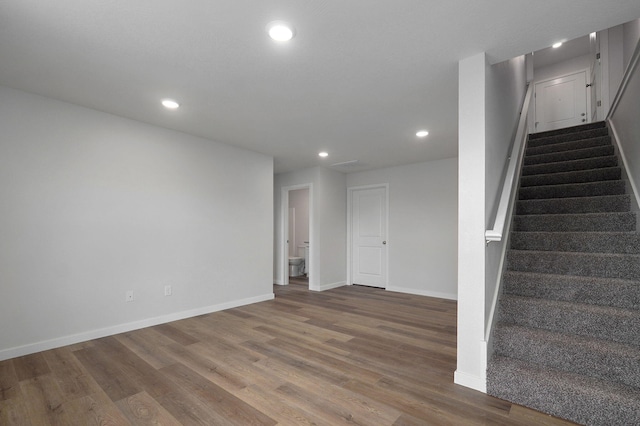 interior space featuring stairway, wood finished floors, and recessed lighting