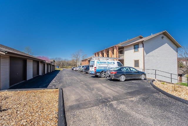 view of road featuring community garages