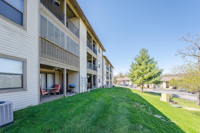 view of community featuring a lawn and a patio