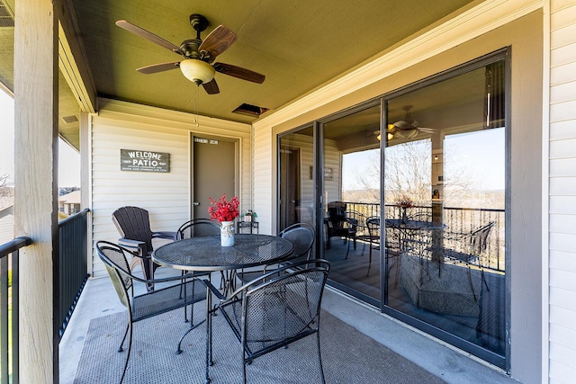 exterior space with a ceiling fan and a balcony