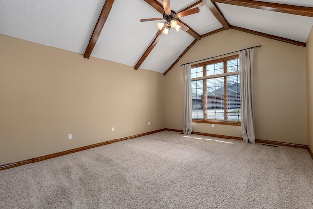 empty room featuring a ceiling fan, light colored carpet, vaulted ceiling with beams, and baseboards