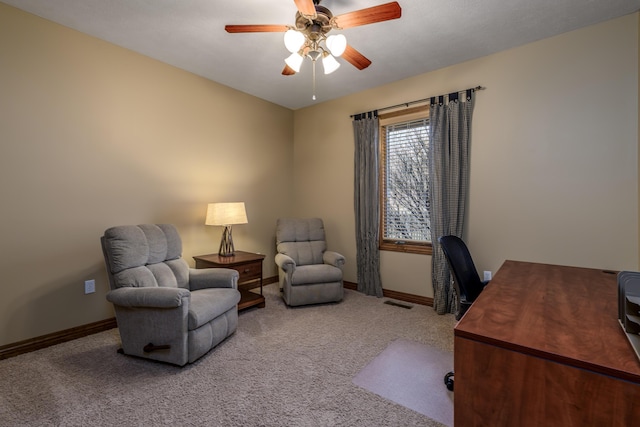 carpeted home office with ceiling fan and baseboards