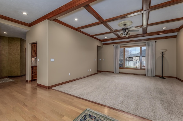 unfurnished living room with baseboards, coffered ceiling, ceiling fan, beamed ceiling, and light wood-style floors