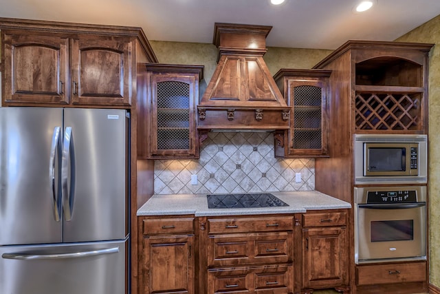 kitchen with glass insert cabinets, appliances with stainless steel finishes, and backsplash