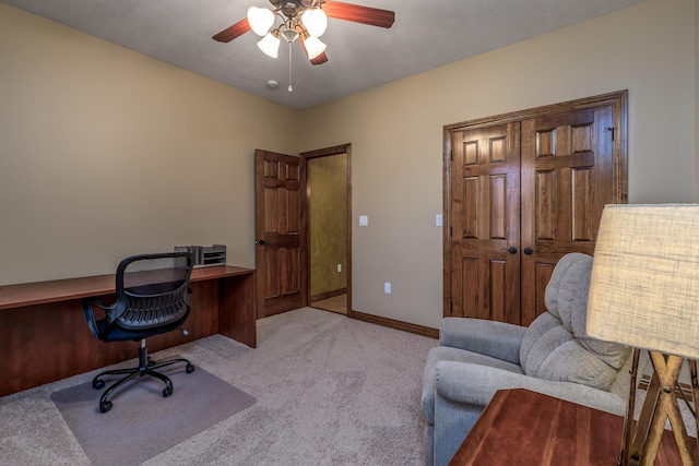 home office featuring carpet floors, a ceiling fan, and baseboards