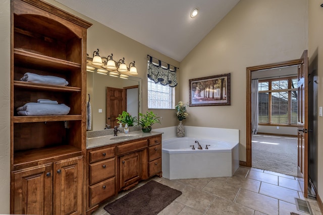 bathroom featuring visible vents, lofted ceiling, tile patterned flooring, vanity, and a bath