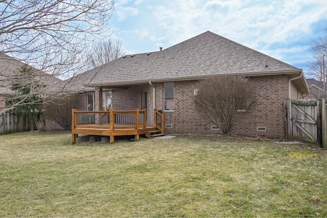 rear view of property with crawl space, a shingled roof, fence, and brick siding