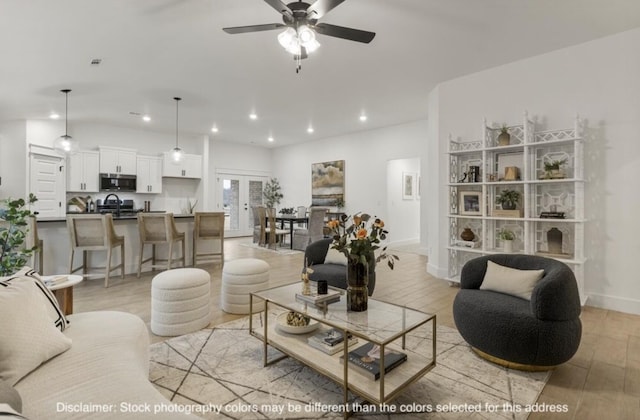 living room featuring baseboards, lofted ceiling, ceiling fan, light wood-style floors, and recessed lighting