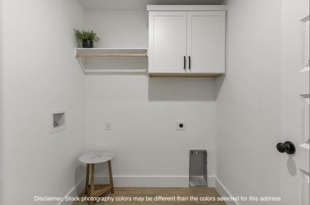 washroom with cabinet space, baseboards, wood finished floors, hookup for an electric dryer, and washer hookup