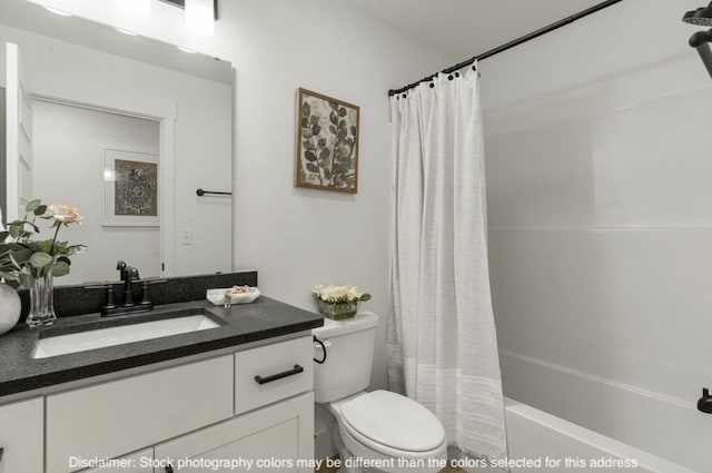 bathroom featuring vanity, toilet, and shower / bath combo with shower curtain