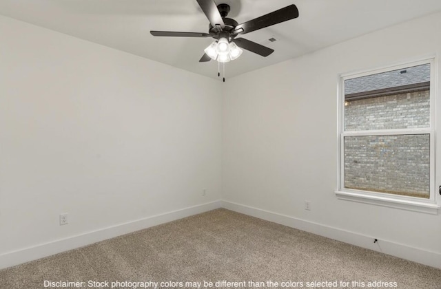 spare room with plenty of natural light, carpet, a ceiling fan, and baseboards