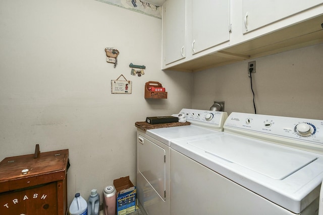 laundry room with washing machine and dryer and cabinet space