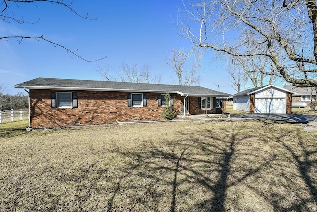 single story home with a garage, brick siding, an outdoor structure, and fence