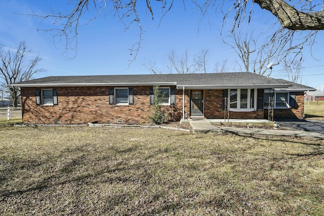 ranch-style house with brick siding, roof with shingles, crawl space, fence, and a front yard