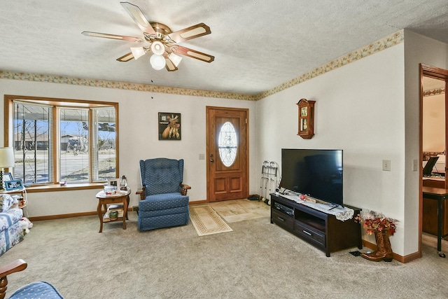 living room with a ceiling fan, carpet, a textured ceiling, and baseboards